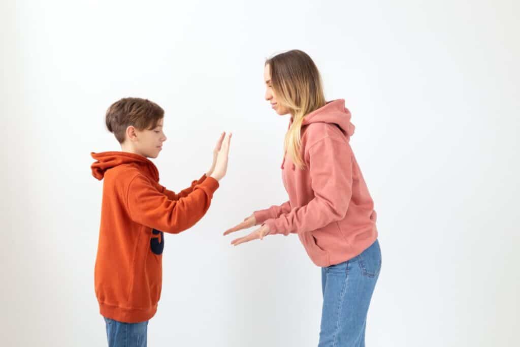 Mom high-fiving teen son.