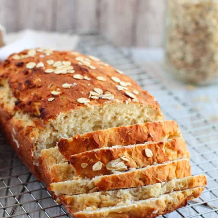 Sliced quick oat bread on a cooling rack.