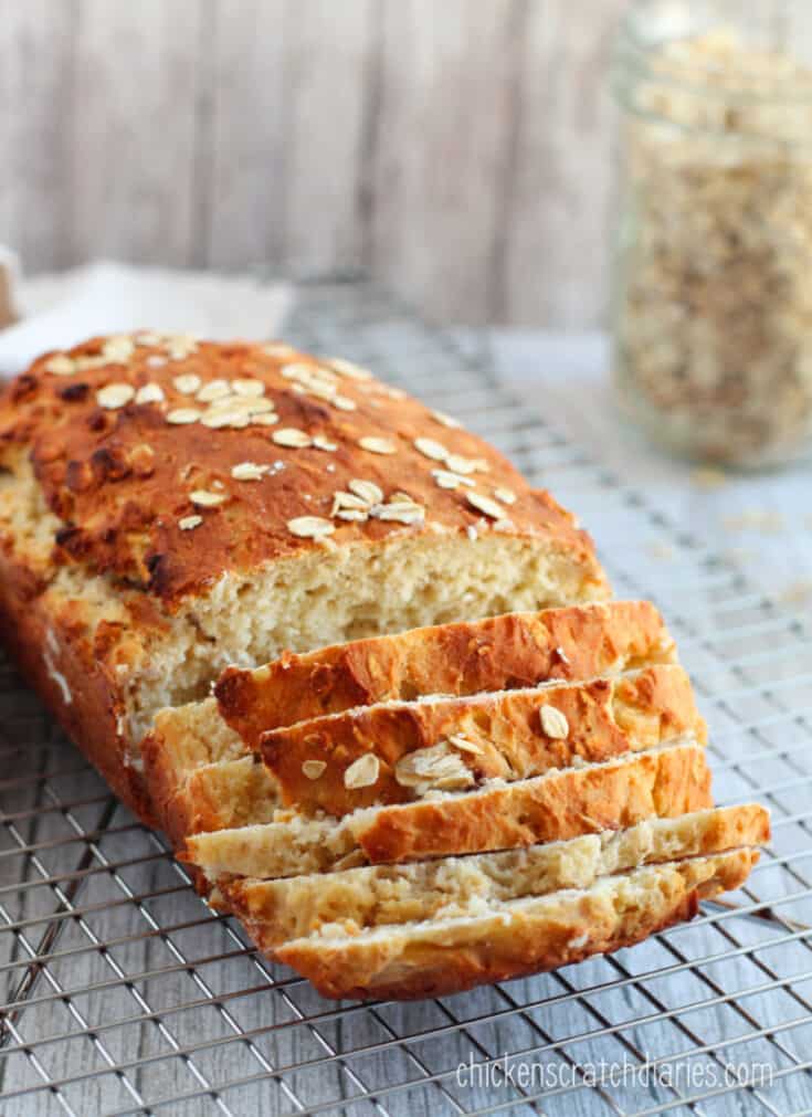 Sliced quick oat bread on a cooling rack.