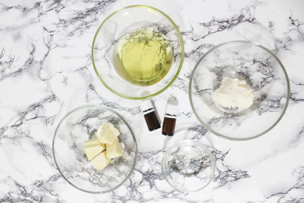 Top view of glass bowls containing the ingredients for making your own whipped body butter.