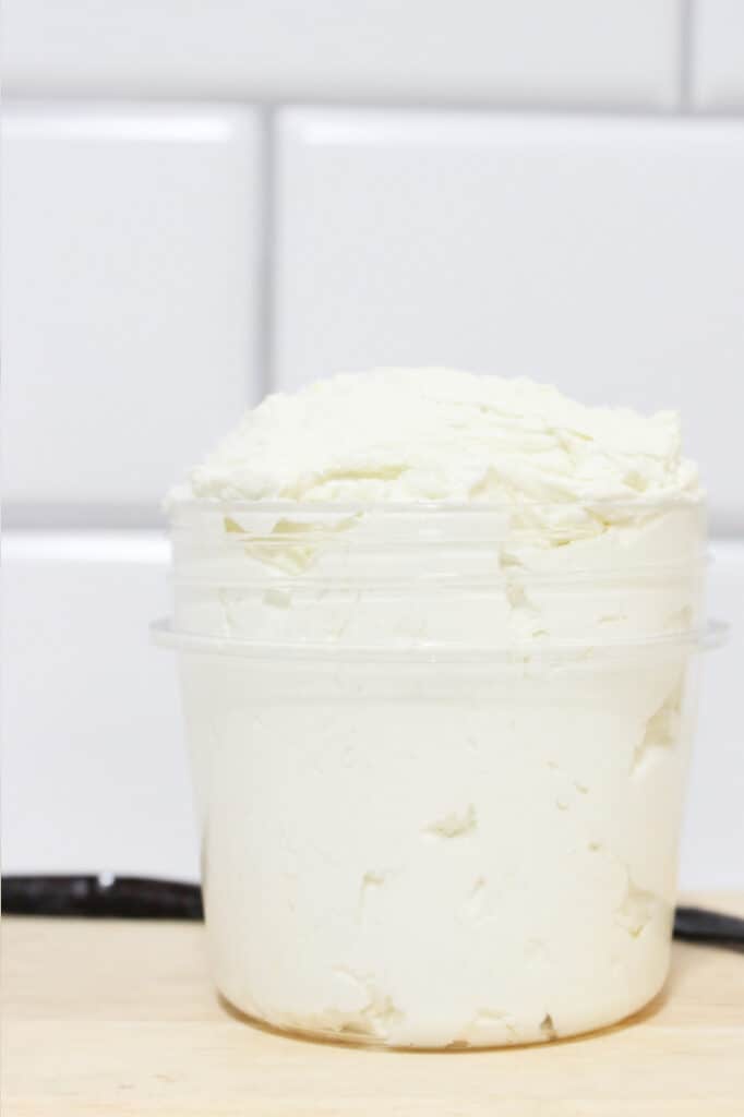 Finished whipped body butter with vanilla bean in background.