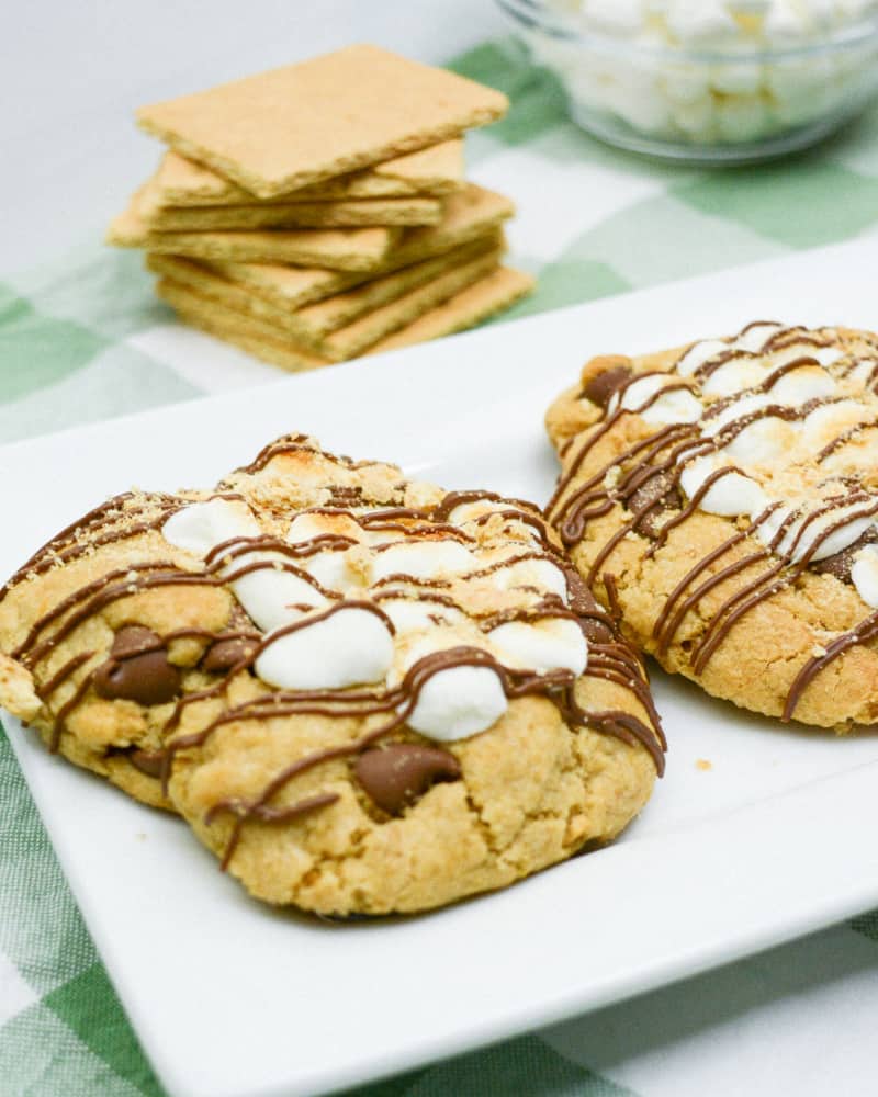 Finished s'mores chocolate chip cookies with chocolate drizzled on top.