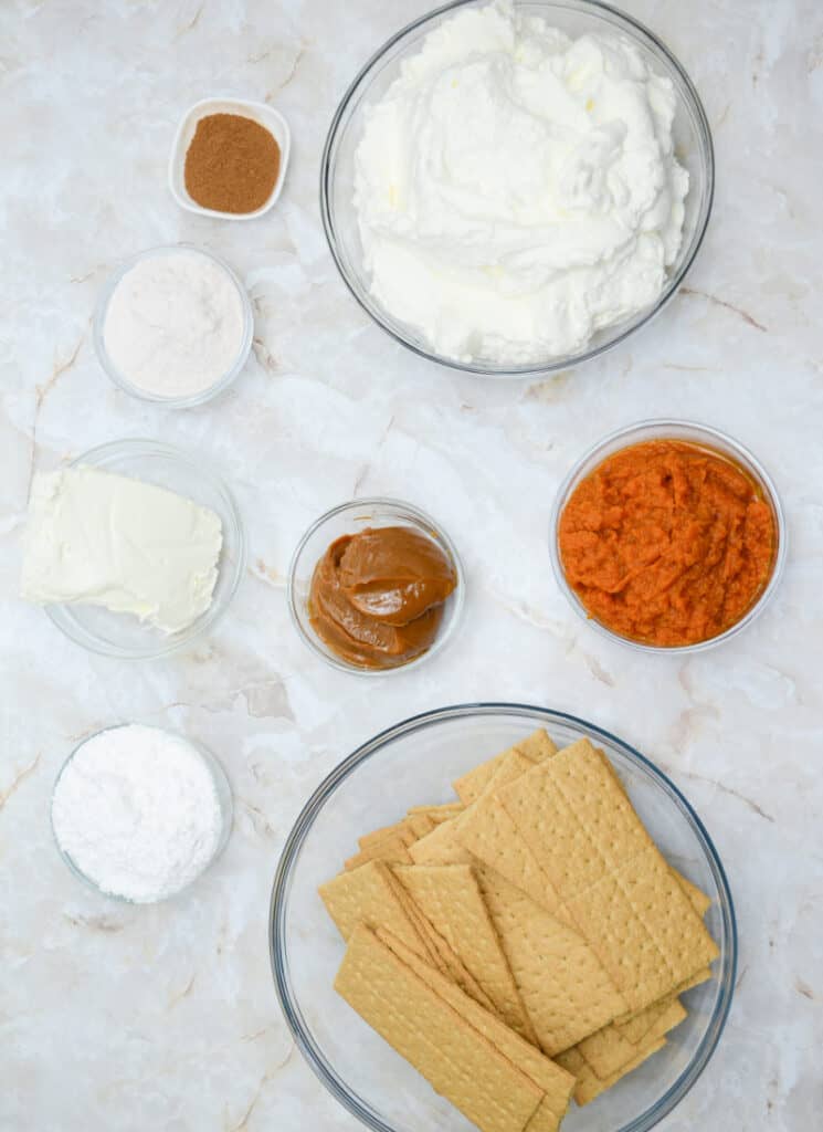 Ingredients for pumpkin icebox cake on a white countertop