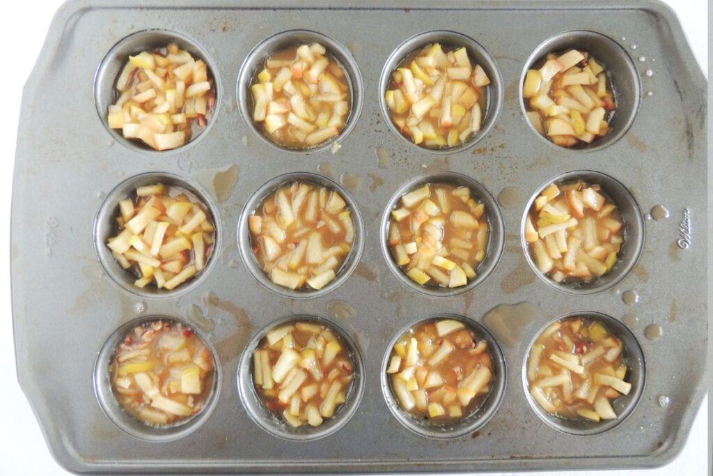 Caramel apple sauce in bottom of each muffin tin well.