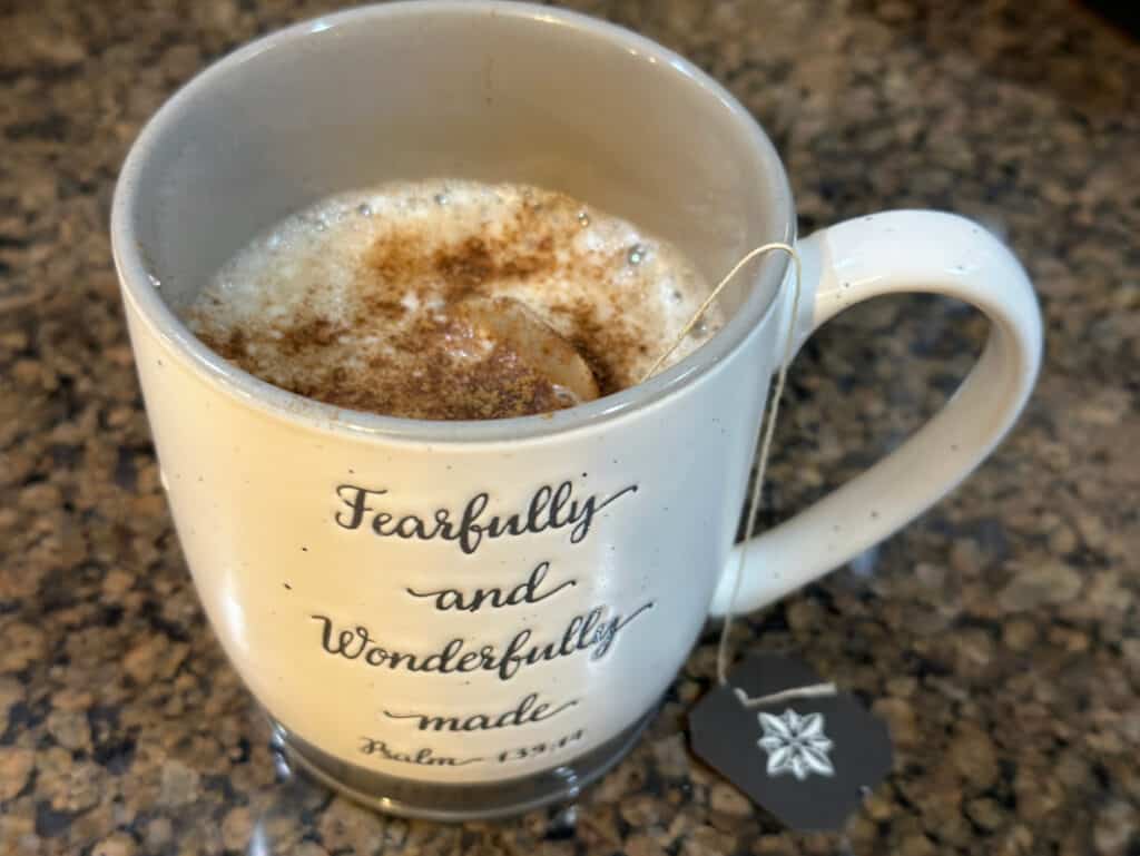 Stoneware mug with my homemade chai tea "latte" and cinnamon on top.