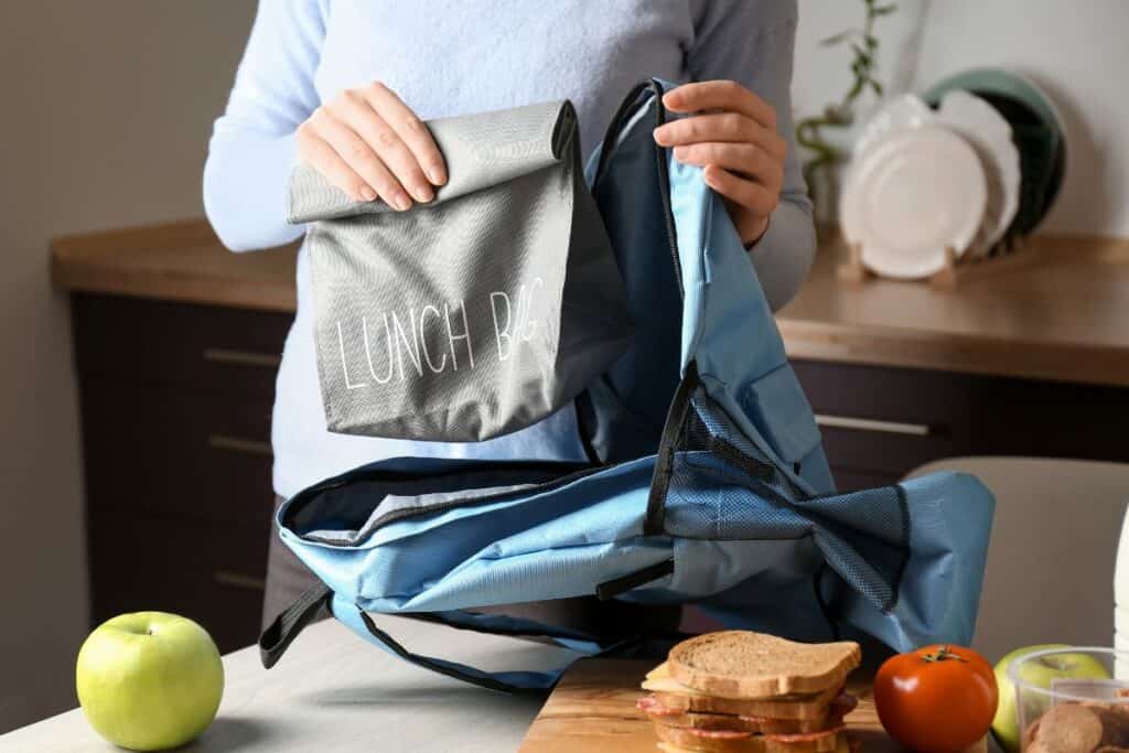 Mom packing kids' school lunches.