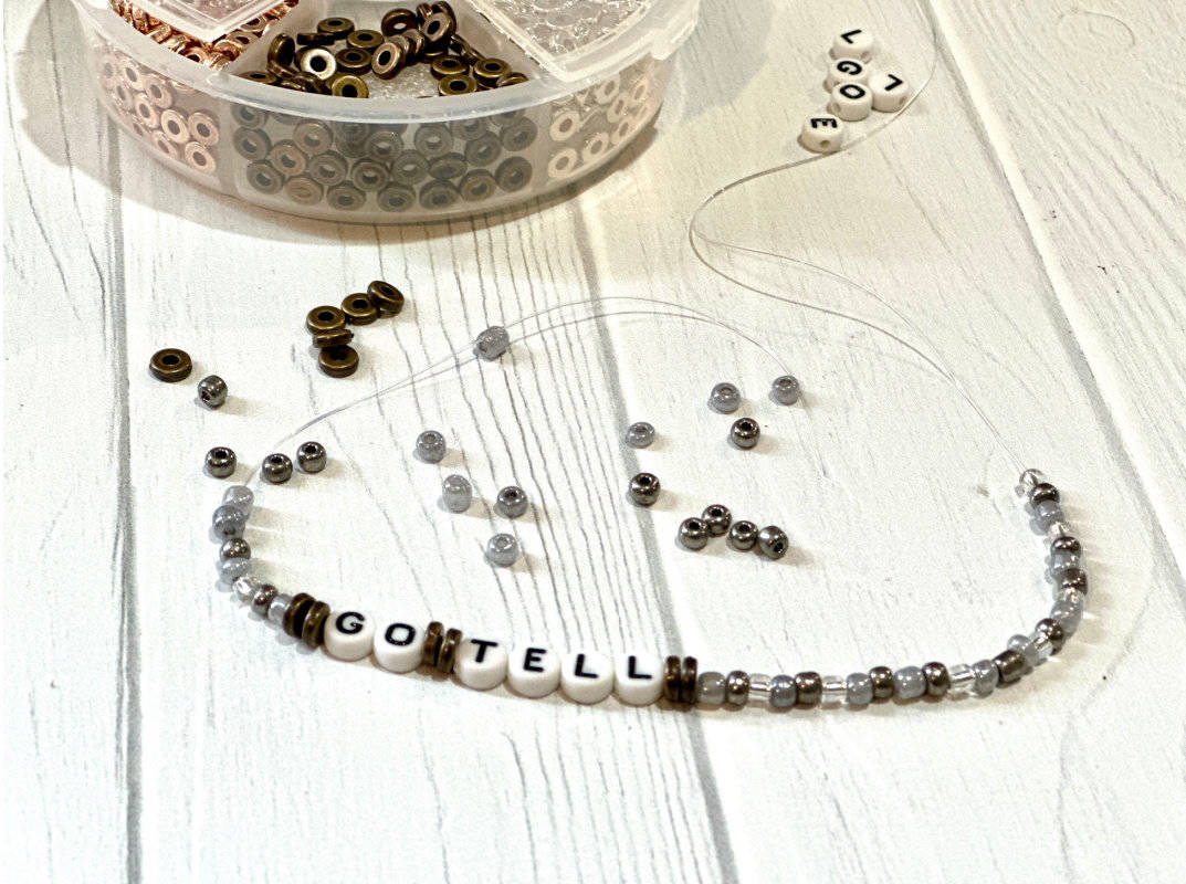 Stringing beads on Go, Tell Bracelets for Easter Craft