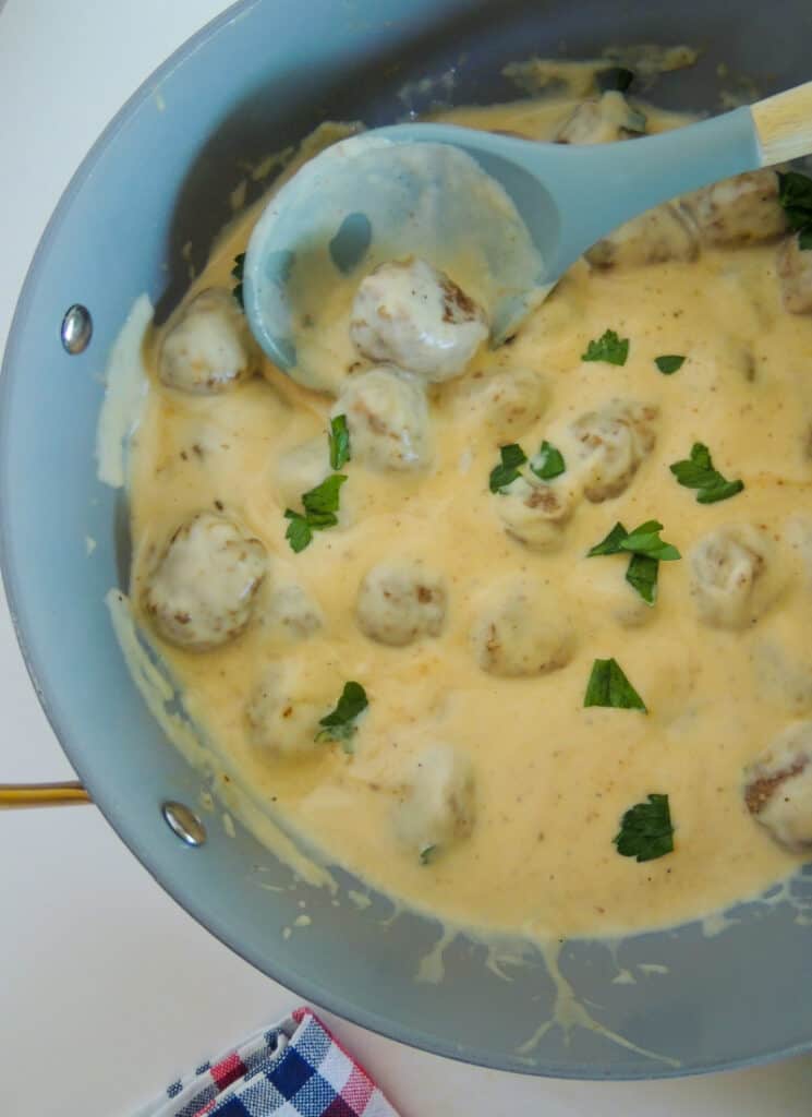 Meatballs in cream gravy, in skillet.