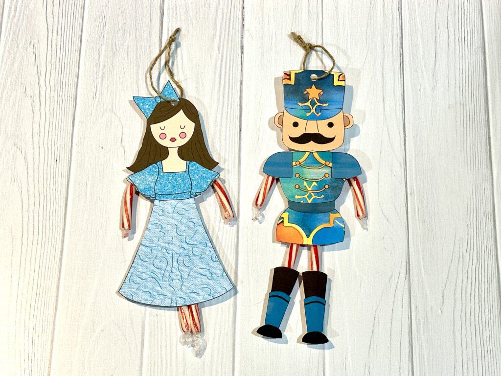Completed Nutcracker craft ornaments on white wooden background.