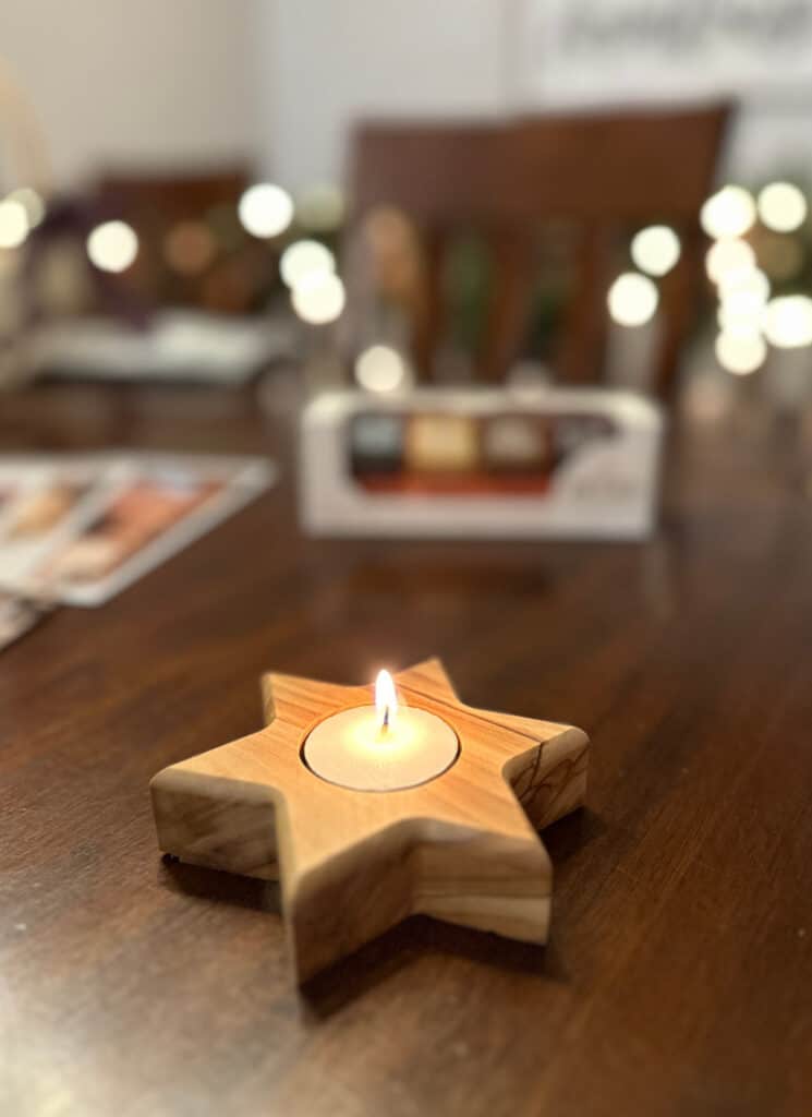Lighting a candle in a 6-pointed star candleholder from Artza box.
