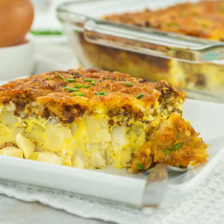 Hashbrown breakfast casserole on a plate on white placemat