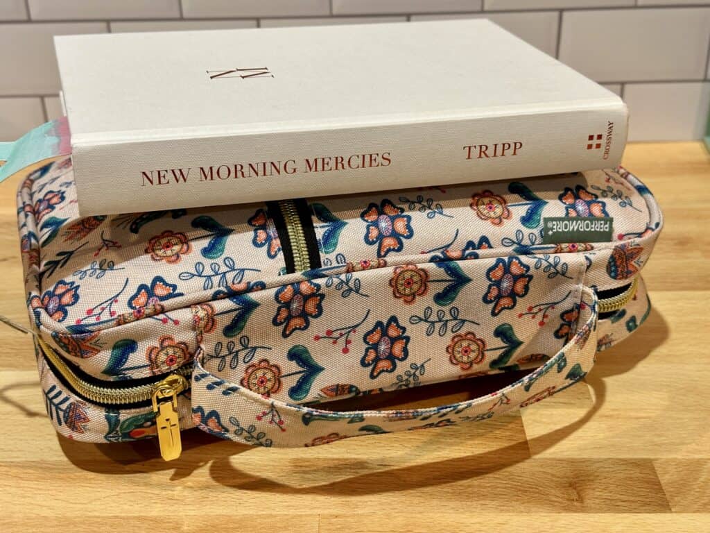 Image of Bible in floral Bible cover and New Morning Mercies devotional on top.