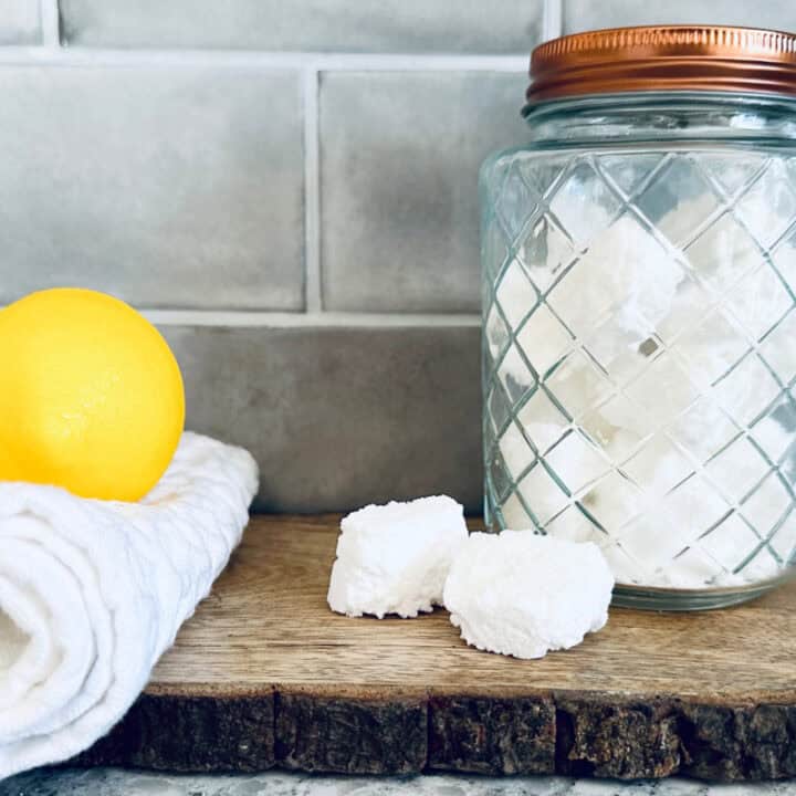 Jar of toilet tabs on a wooden slab on countertop