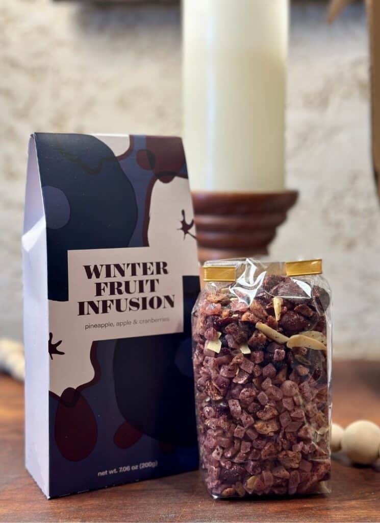 Dried fruit infusion in a sealed clear plastic bag with decor in background.