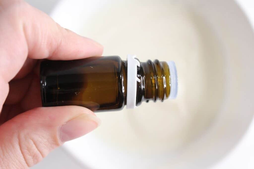 Pouring essential oils into the grout cleaner ingredients.