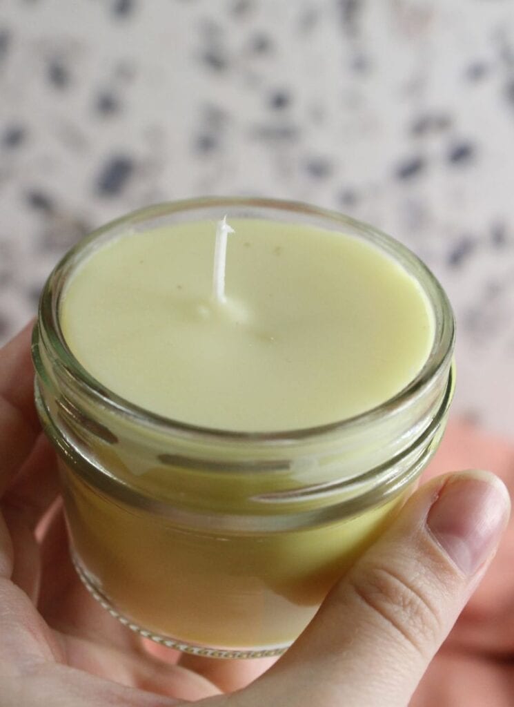 Holding finished beeswax candle.