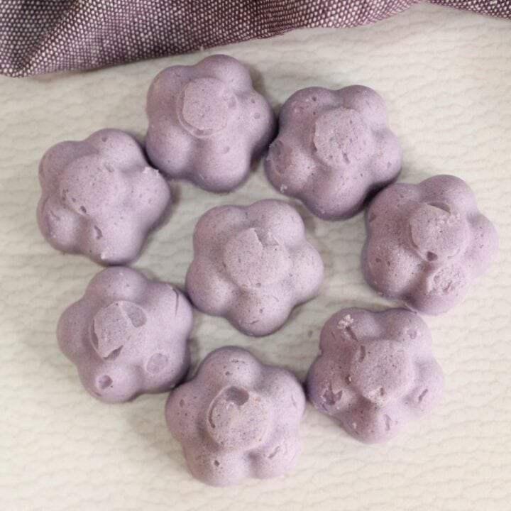 Bubble bath melts in shape of flowers in a circle on tabletop.