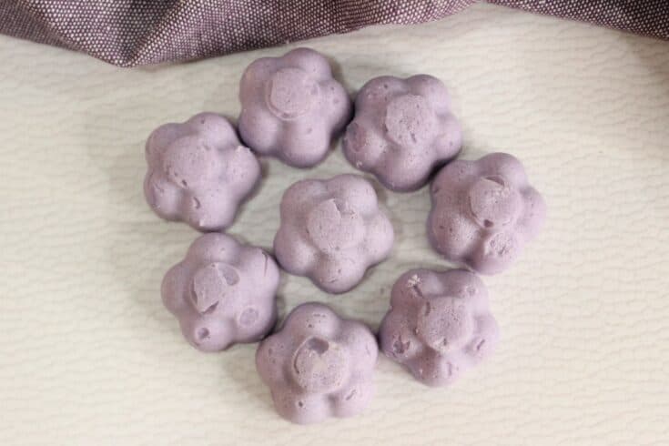 Bubble bath melts in shape of flowers in a circle on tabletop.