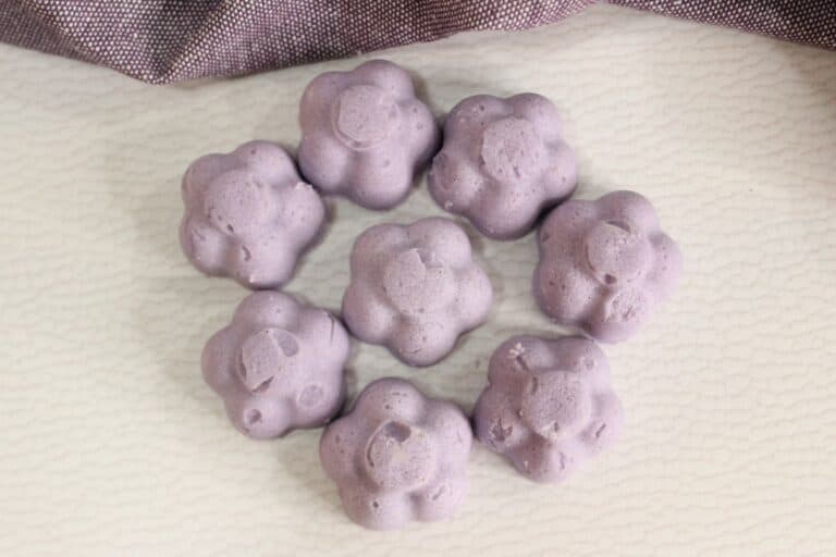Bubble bath melts in shape of flowers in a circle on tabletop.