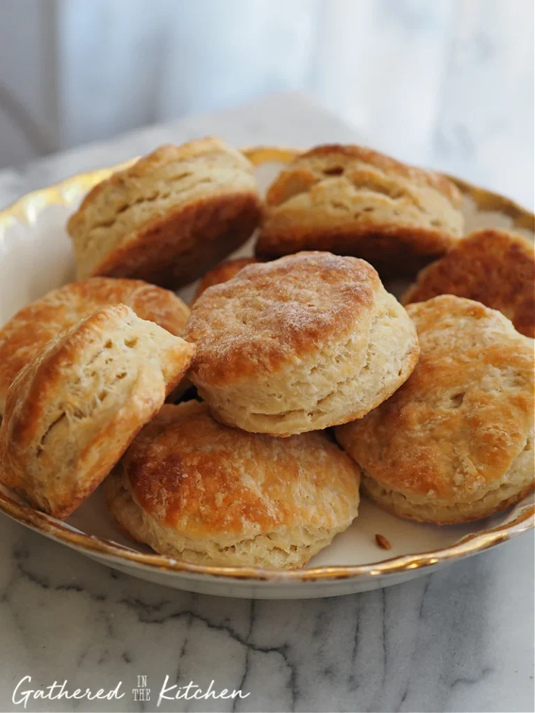 Pile of biscuits on a gold-edged platter.