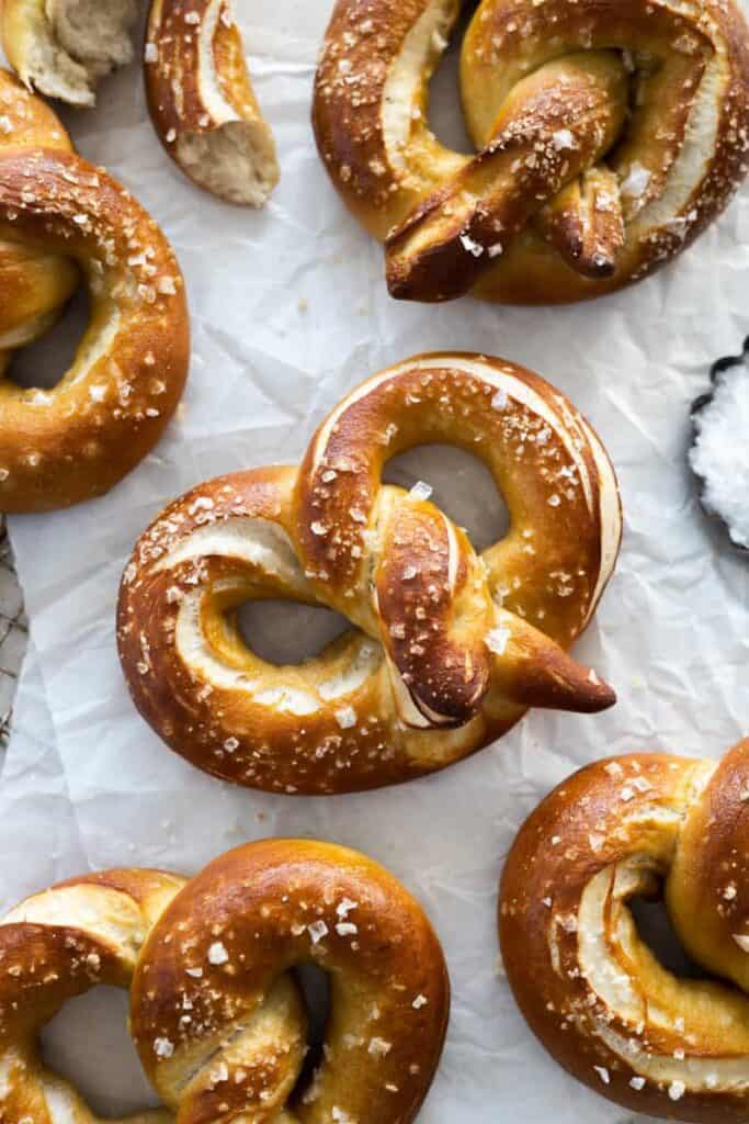 Finished and salted pretzels on parchment paper.