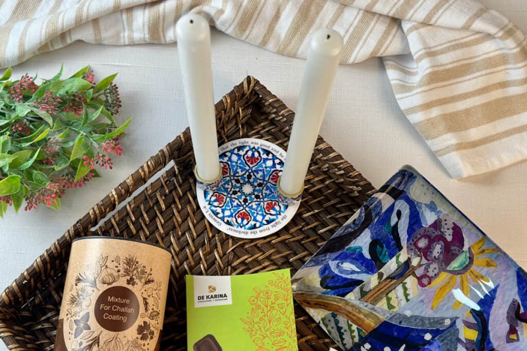 Candle holders with taper candles along with other items from Artza box, top view.