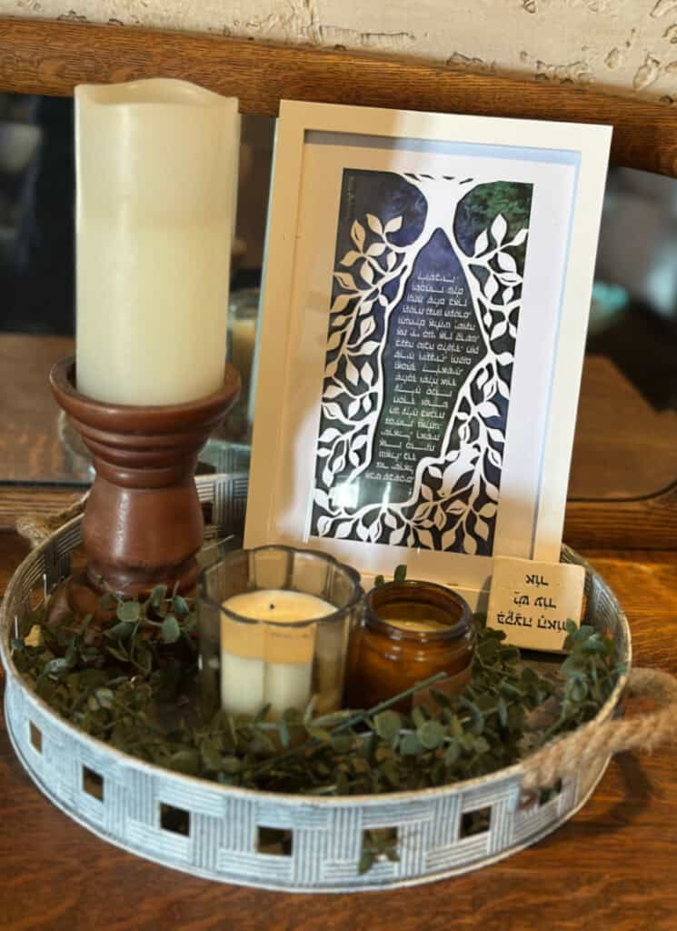 Metal tray holding candles and the hand cut paper artwork from Artza.