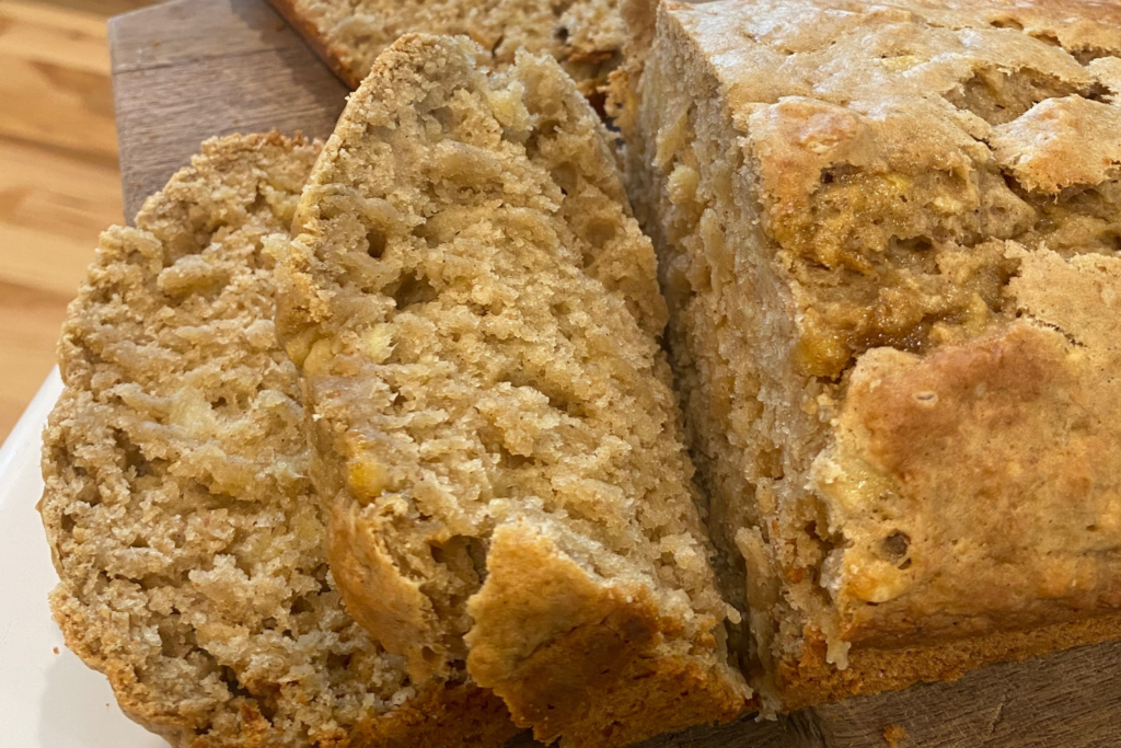 Sliced banana bread loaf on a cutting board.