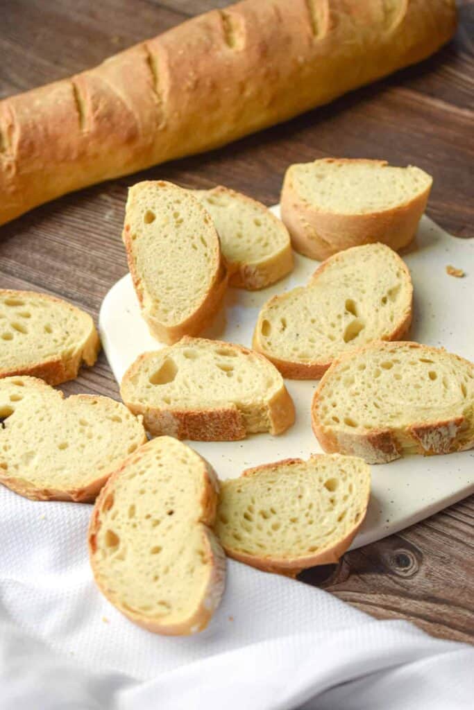 Long french bread loaf cut into slices.