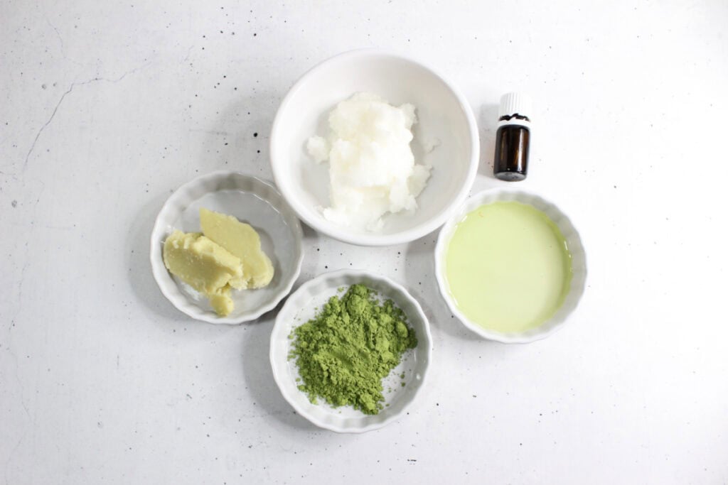 Ceramic containers with each ingredient for matcha face cream recipe.