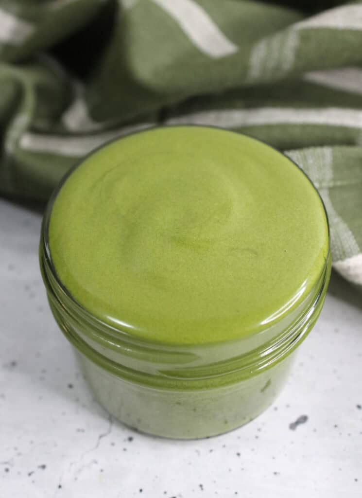 Top view of jar of matcha face cream in a small jar.
