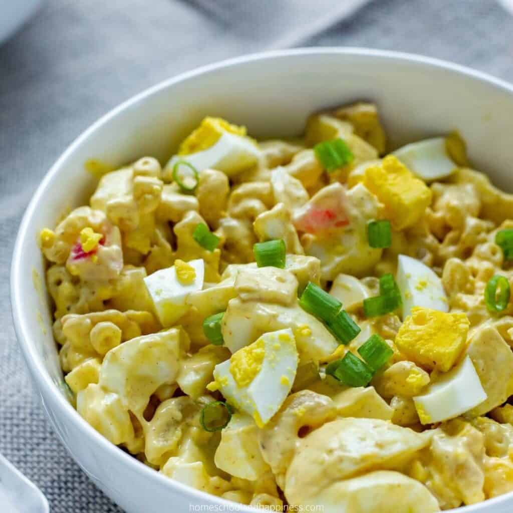 close up of bowl of deviled egg macaroni pasta salad.