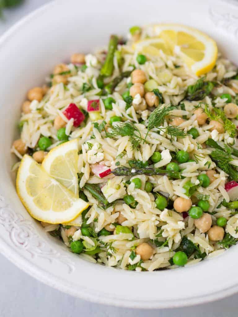 Orzo pasta salad with fresh dill and lemon in a bowl.