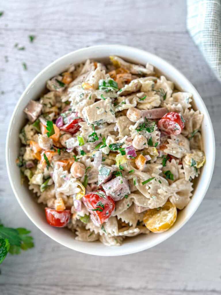 High protein pasta salad with ham and chicken and fresh vegetables and creamy sauce.