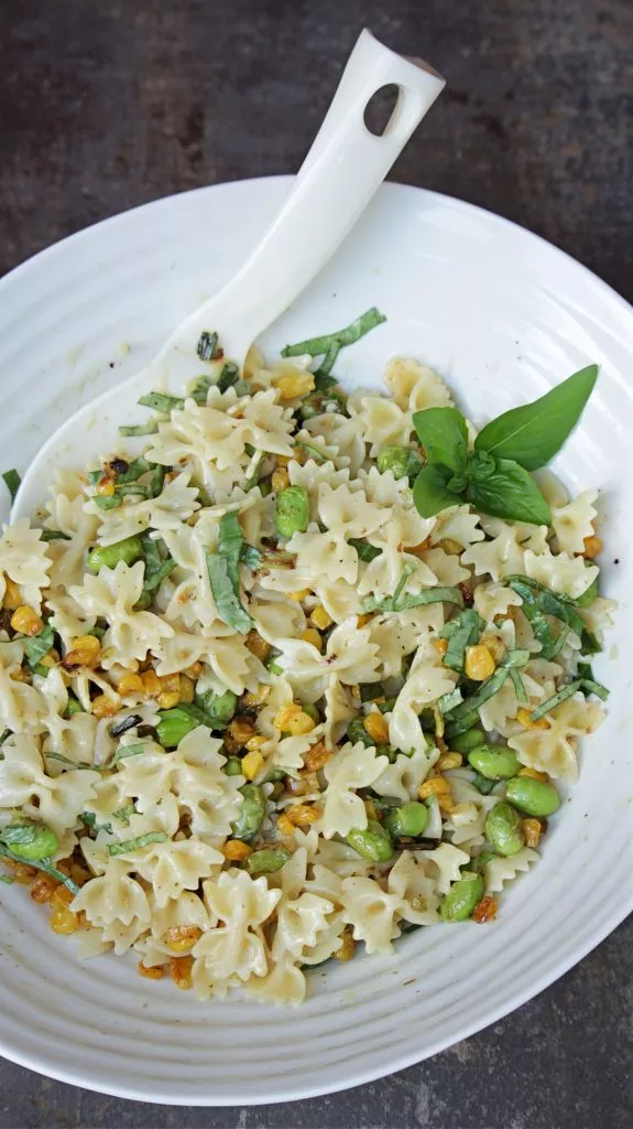 Small bowtie pasta with vegetables and creamy dressing.