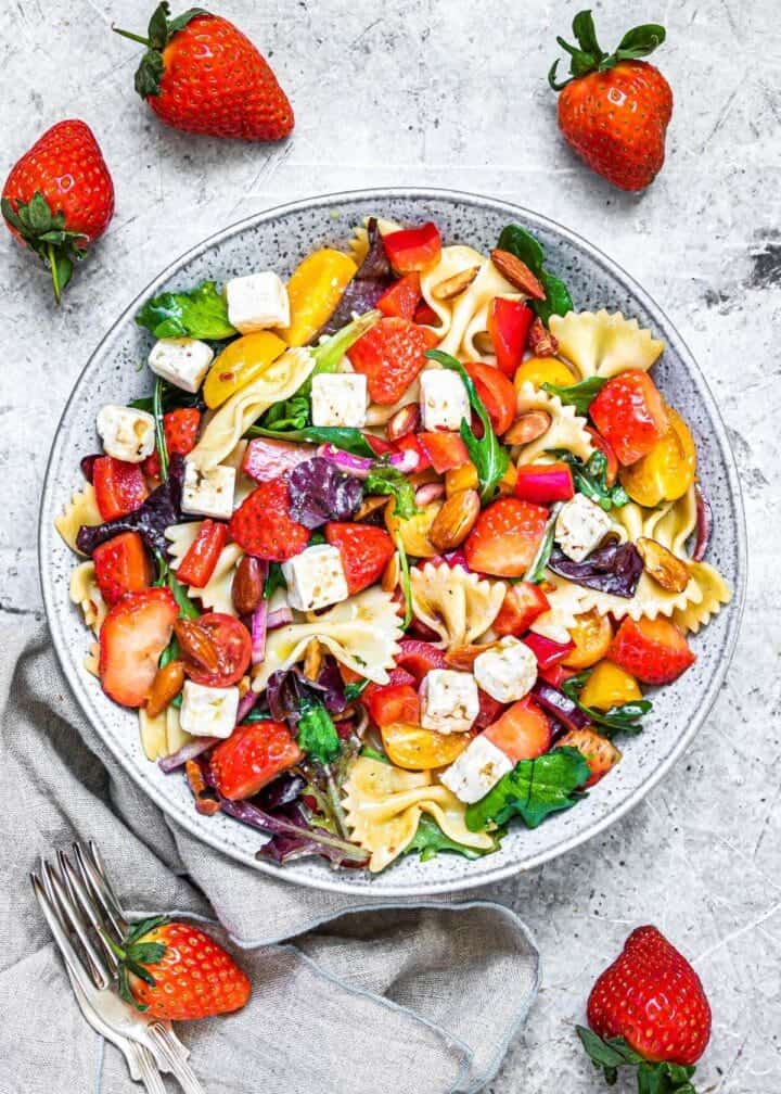 Strawberry pasta salad with cheese, almonds and a balsamic glaze.