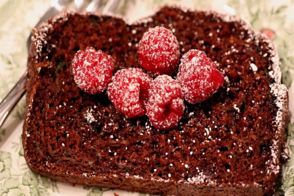 slice of chocolate zucchini bread topped with raspberries