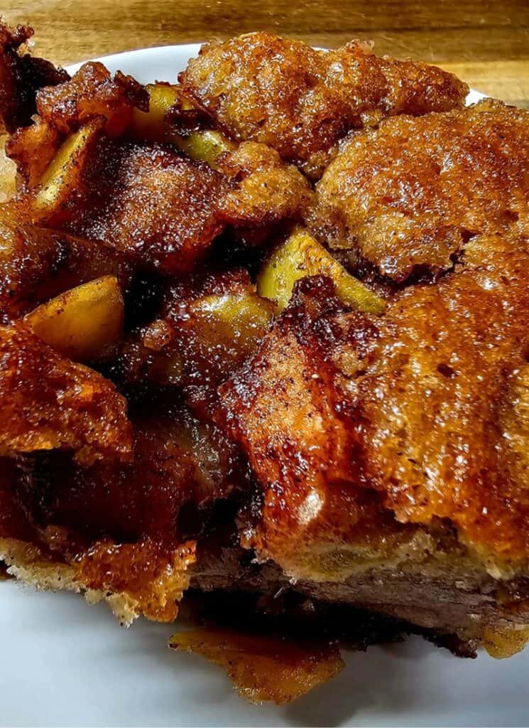 Closeup of cinnamon cake with fresh apples baked inside.