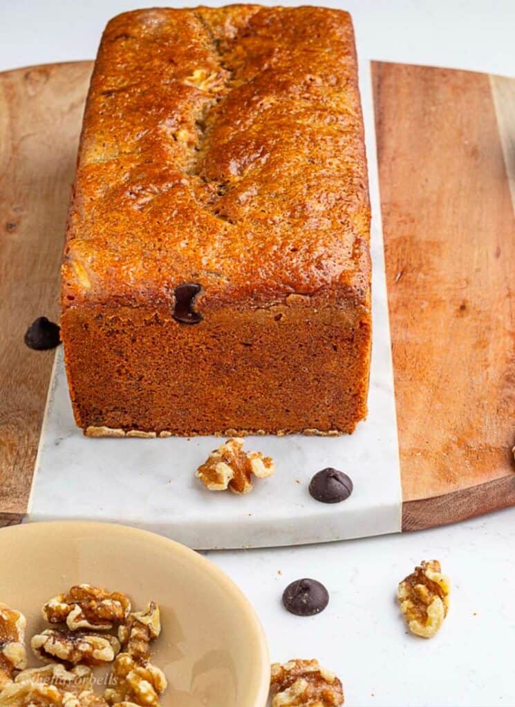 Loaf of zucchini bread on cutting board.