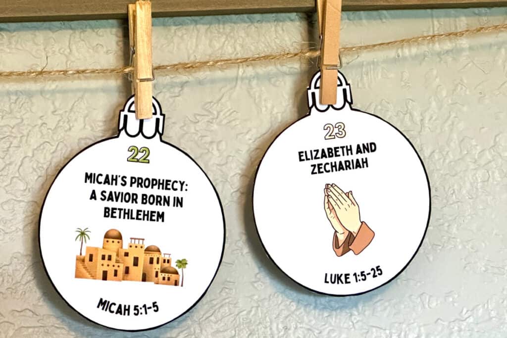 Two Jesse tree symbols clipped to a twine strung across a wall.