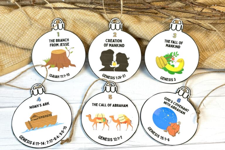 Jesse tree ornaments on white wood table with natural decor.