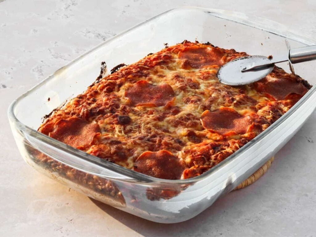 Focaccia pizza baked in a glass baking dish.