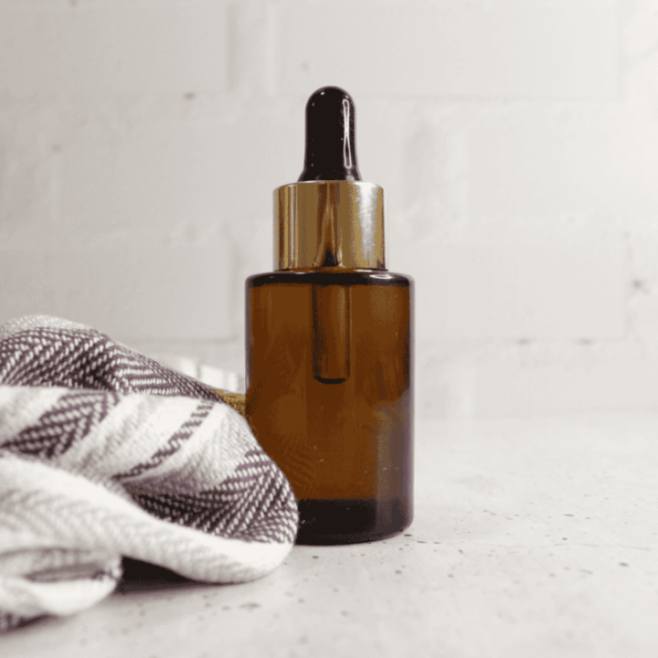 Glass bottle of makeup remover on countertop