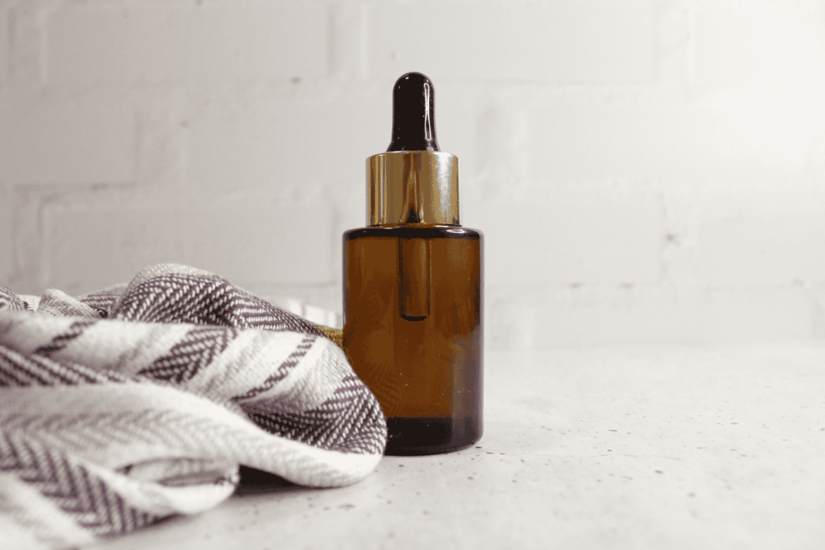 Glass bottle of makeup remover on countertop