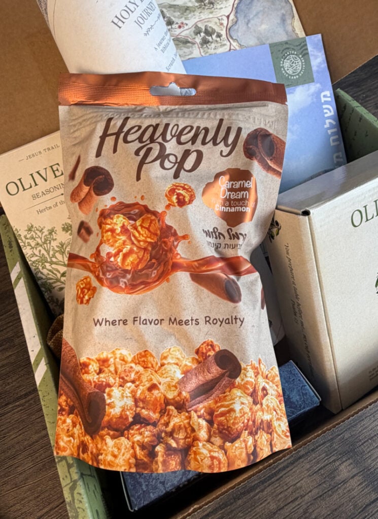 closeup of bag of heavenly pop caramel dream popcorn inside open subscription box.