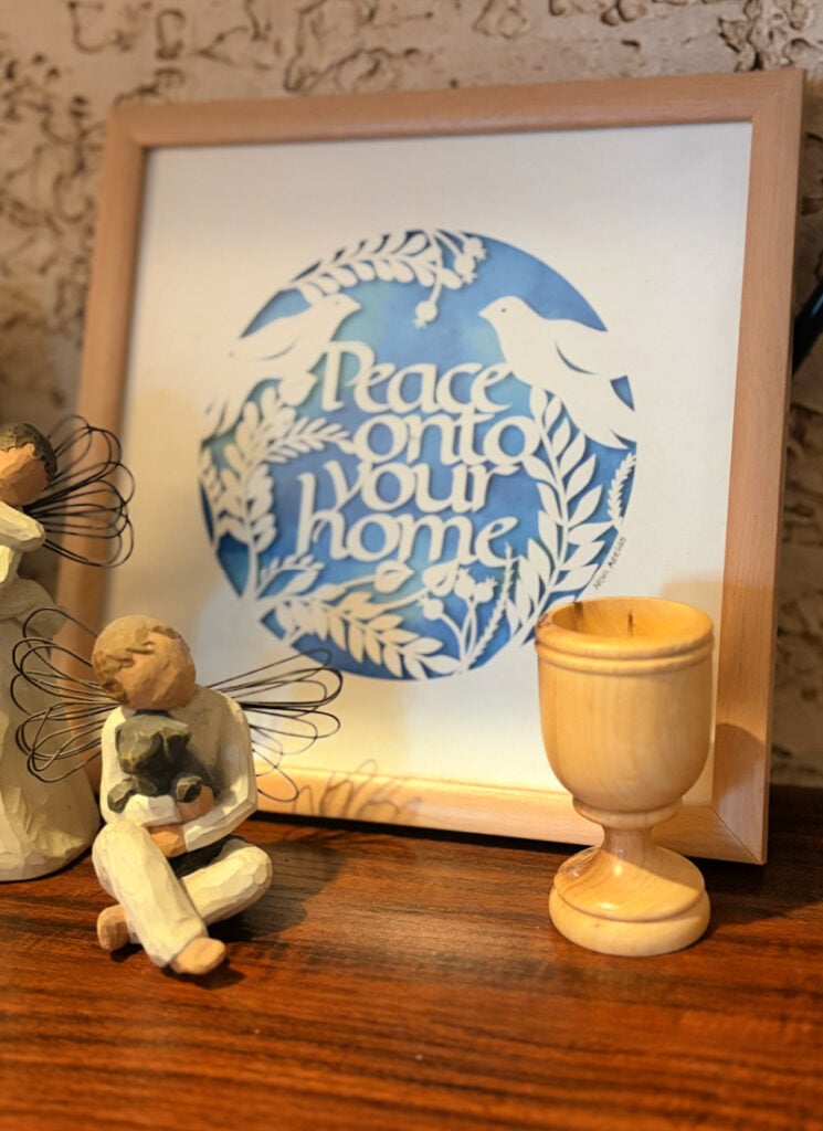 Display with wooden cup and handmade artwork from Israel.